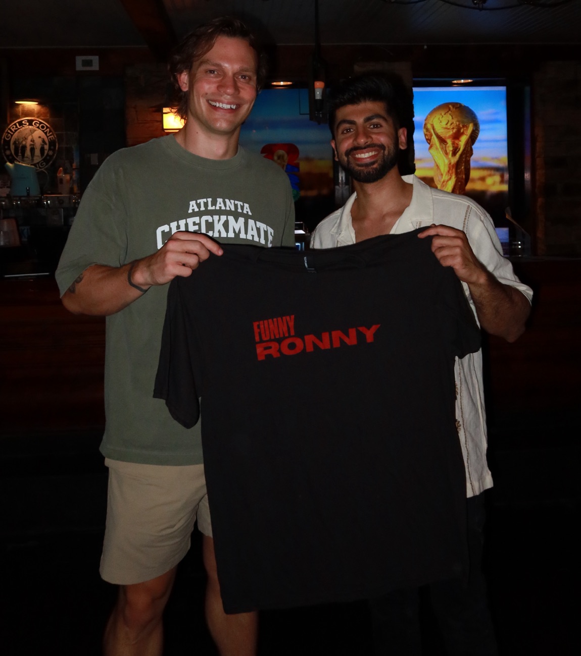 Matt Thomas and Rahul Dhiman holding up a Funny Ronny shirt